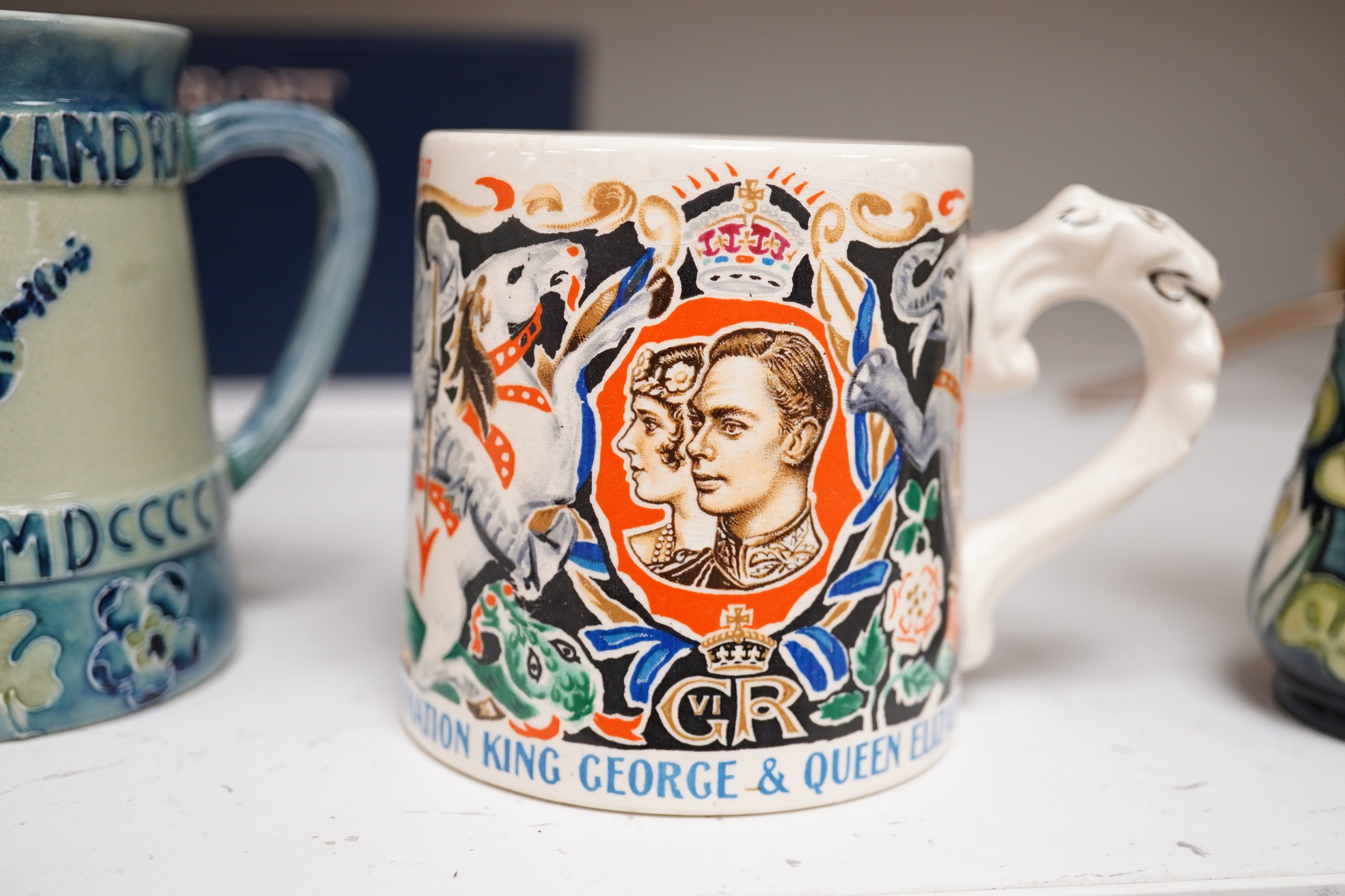 Ceramics comprising a Moorcroft mug (restored), a Dame Laura Knight mug, both Royal commemorative, Moorcroft vase and Clarice Cliff dish, largest 26cm in diameter. Condition - varies